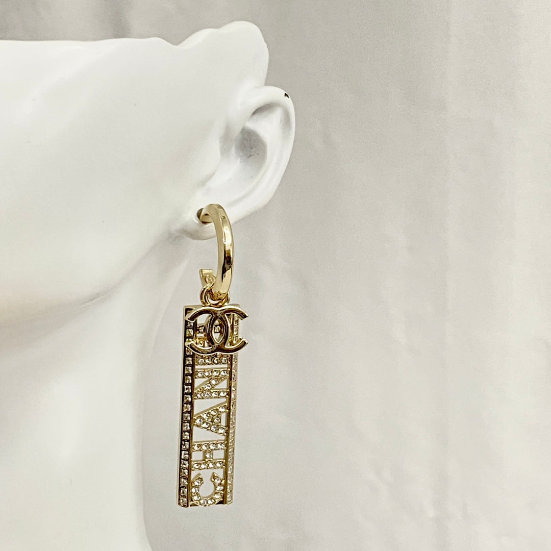 CC TEXT DIAMOND PAVED LIGHT GOLD DROP EARRINGS