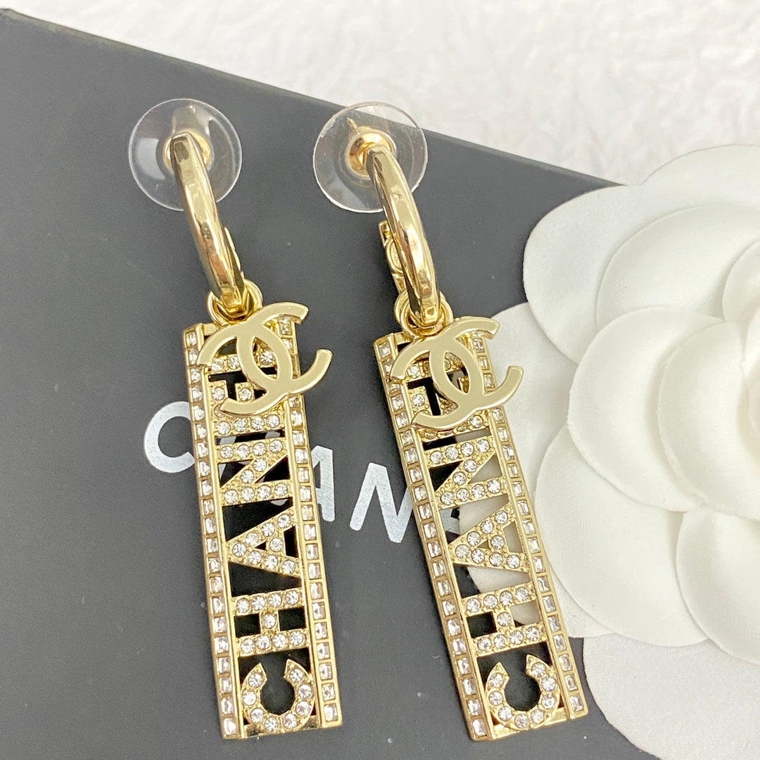 CC TEXT DIAMOND PAVED LIGHT GOLD DROP EARRINGS